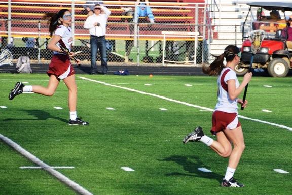 Maddie Royle, freshman,  runs down the field as Layne Stikeleather, sophomore, carries the ball.