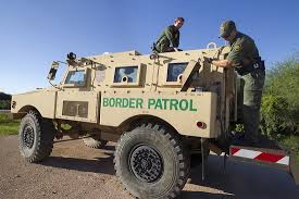 A Border Patrol vehicle transporting migrants in custody 